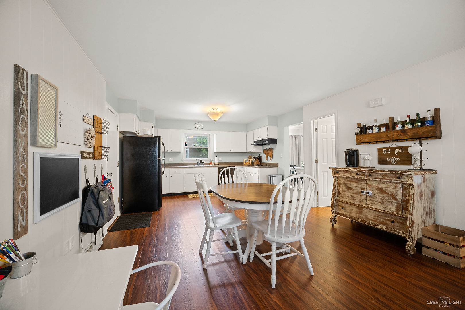 800 Russell Road DeKalb, IL 60115 - Photo 8 of 19 a view of a dining room with furniture a kitchen and chandelier