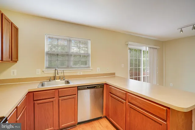 a kitchen with granite countertop cabinets sink and window