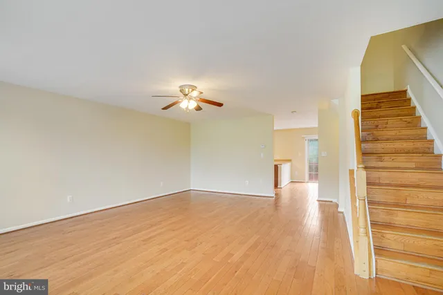 a view of a room with wooden floor and staircase