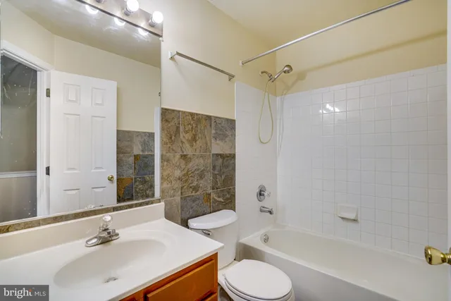 a bathroom with a sink toilet tub and shower