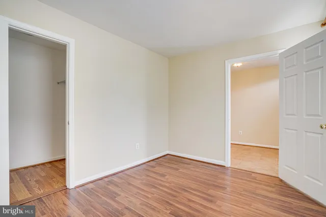an empty room with wooden floor