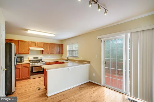 a kitchen with a stove a sink and a refrigerator
