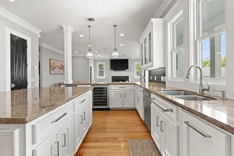 a large kitchen with stainless steel appliances granite countertop a lot of counter space and a sink