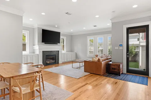 a living room with furniture a flat screen tv and a fireplace