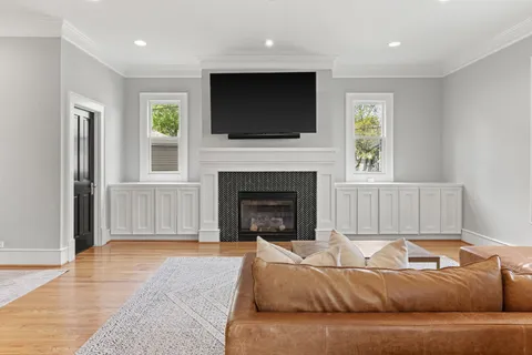 a living room with a fireplace and a flat screen tv