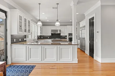 a open kitchen with stainless steel appliances granite countertop a stove a sink and a refrigerator
