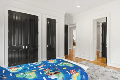 a bedroom with a bed and a dresser in it