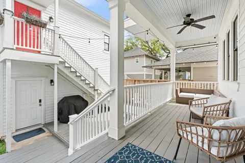 a view of a porch with wooden floor and outdoor seating