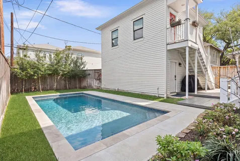 a view of a patio with swimming pool table and chairs