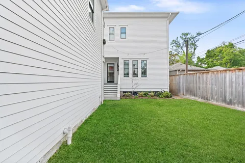 a view of a backyard with wooden fence