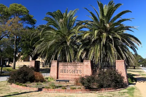 a sign board with palm trees