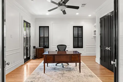 a view of a workspace with furniture and a window