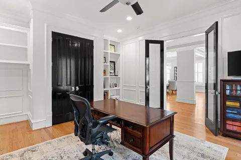 a living room with furniture a flat screen tv and a table