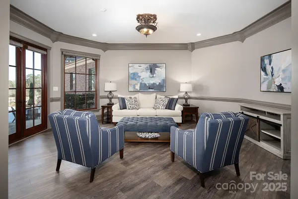 a bedroom with furniture wooden floor and window
