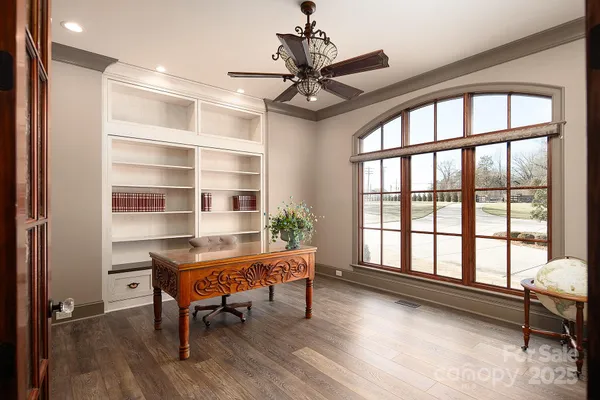a bedroom with a bed mirror and window