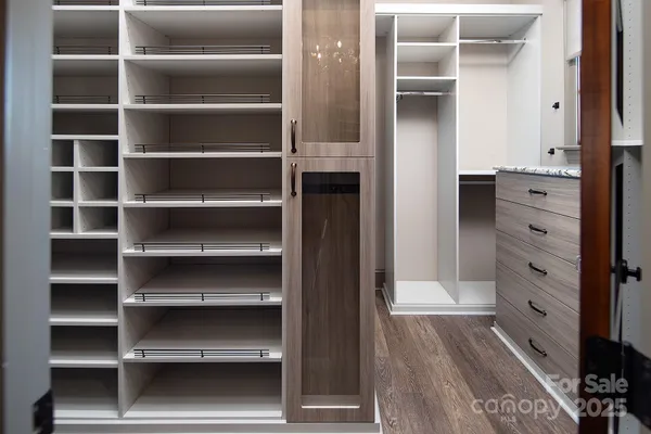 a kitchen with a wooden floor and cabinets