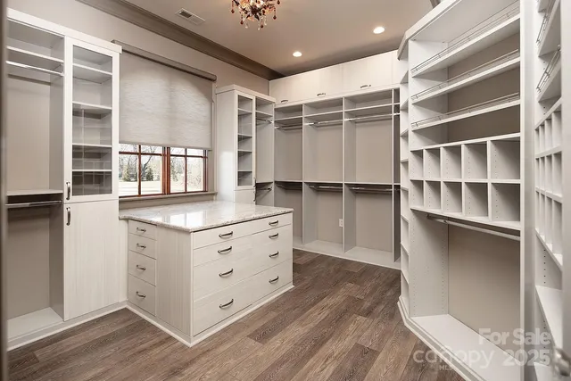 a spacious bedroom with a bed mirror and window