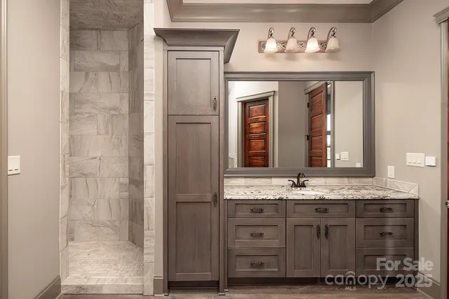 a spacious bedroom with a bed and a chandelier