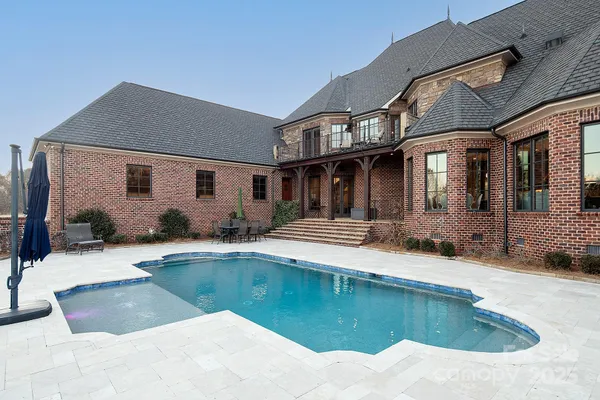 a view of a patio with table and chairs a barbeque with wooden floor and fence