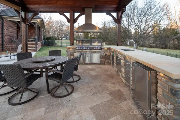 a balcony with wooden floor table and chairs