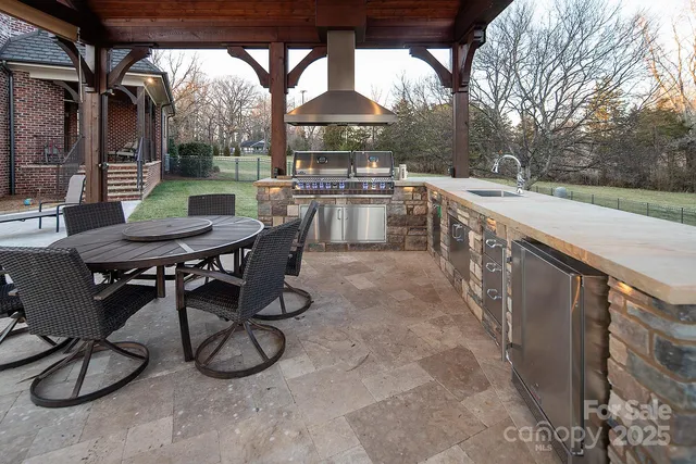 a balcony with wooden floor table and chairs
