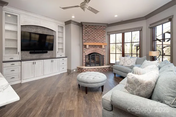 a living room with furniture a flat screen tv and a fireplace