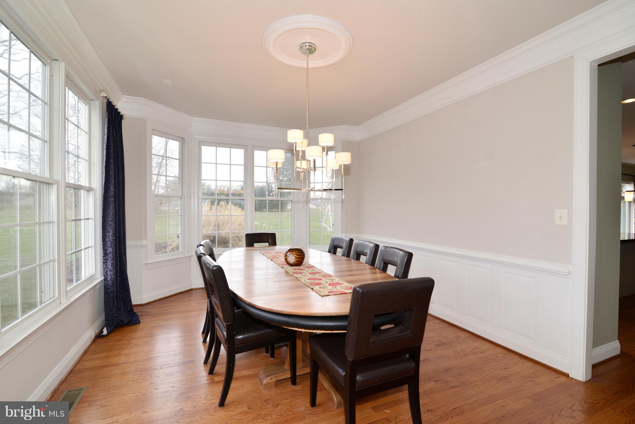 1763 Proffit Road Vienna, VA 22182 - Photo 11 of 30 a view of a dining room with furniture window and wooden floor