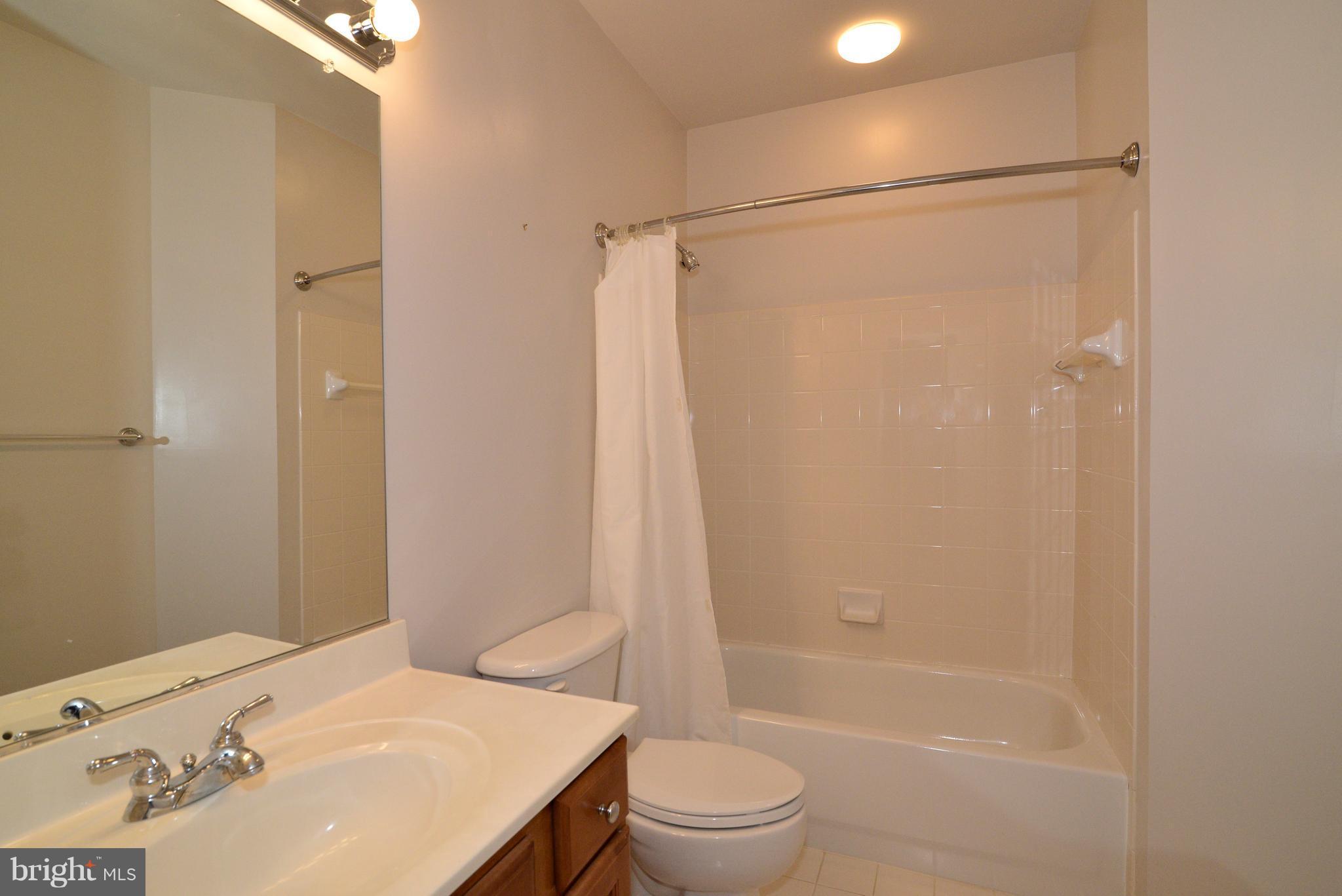 1763 Proffit Road Vienna, VA 22182 - Photo 21 of 30 a bathroom with a sink toilet and shower