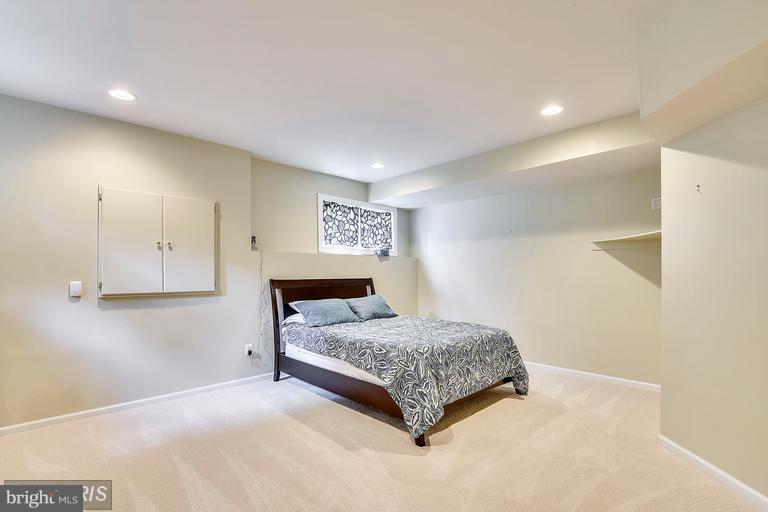 1763 Proffit Road Vienna, VA 22182 - Photo 22 of 30 a bedroom with a bed and a lamp