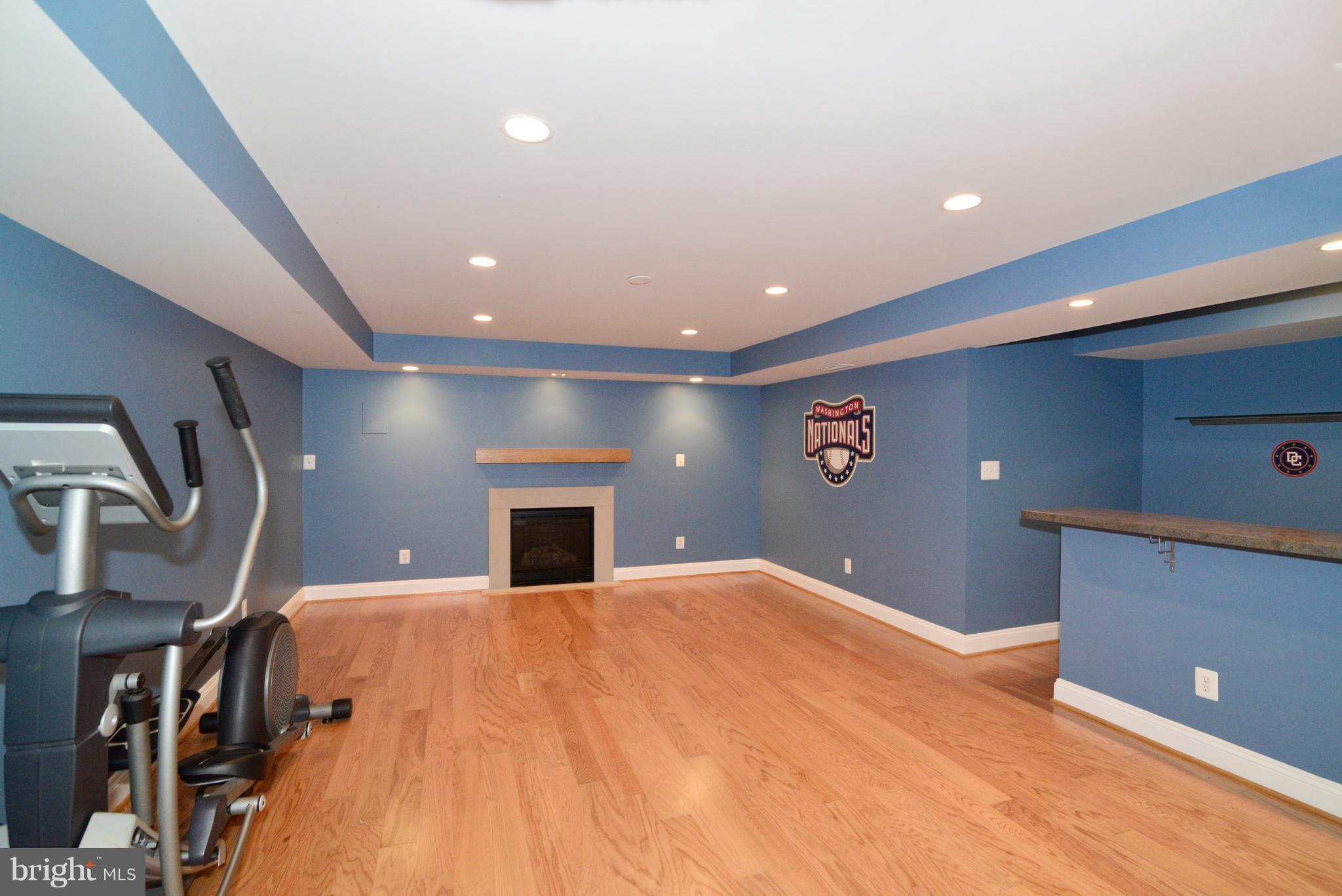 1763 Proffit Road Vienna, VA 22182 - Photo 26 of 30 a view of an empty room with wooden floor and a kitchen