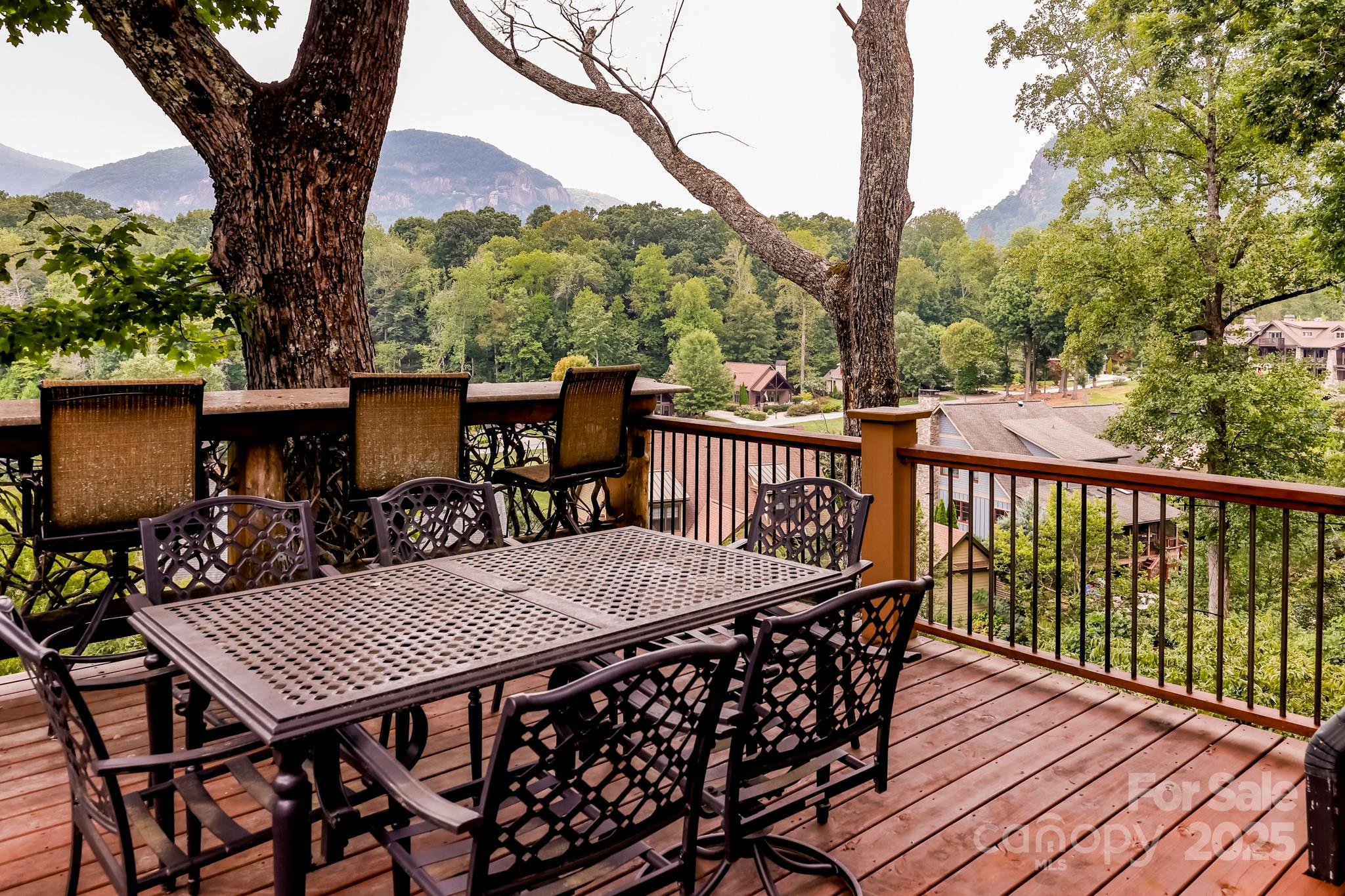 200 Chapel Point Road Lake Lure, NC 28746 - Photo 12 of 48 a view of a roof deck with table and chairs and wooden floor