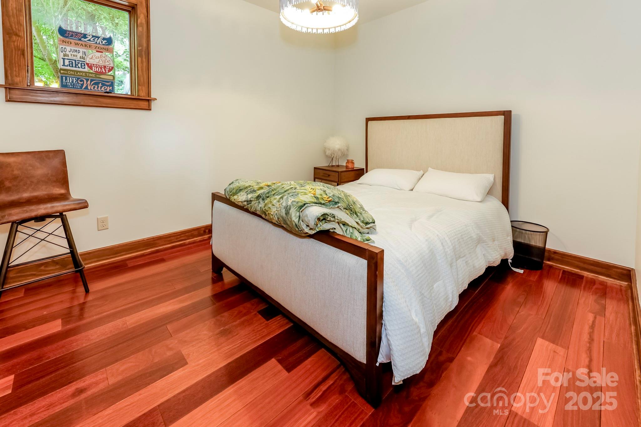 200 Chapel Point Road Lake Lure, NC 28746 - Photo 22 of 48 a bed room with a bed and a chair