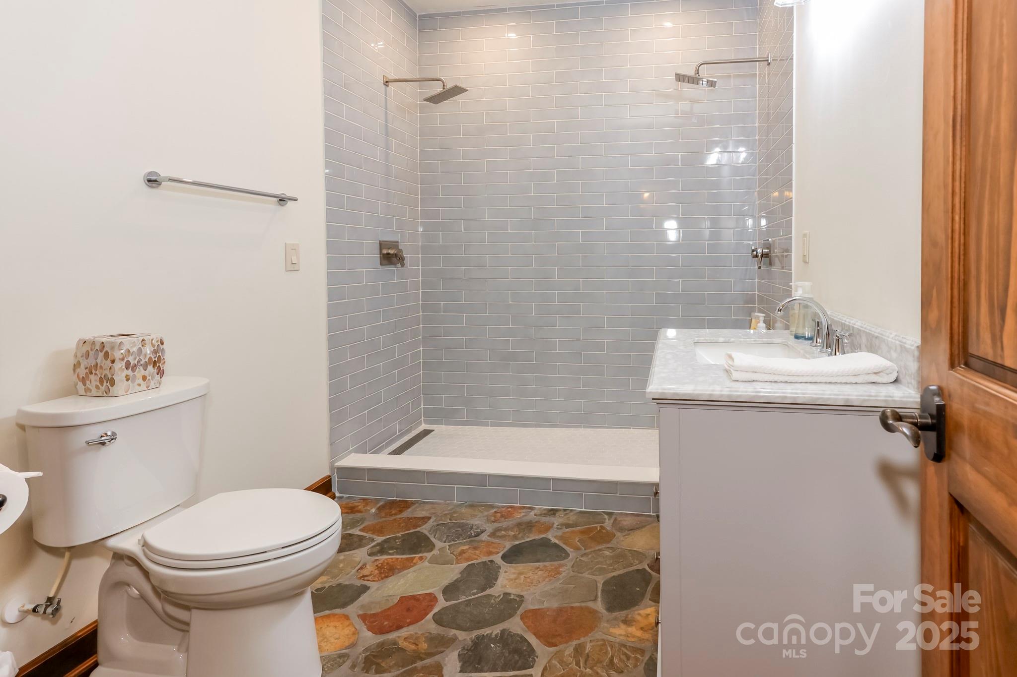 200 Chapel Point Road Lake Lure, NC 28746 - Photo 23 of 48 a bathroom with a sink toilet and shower