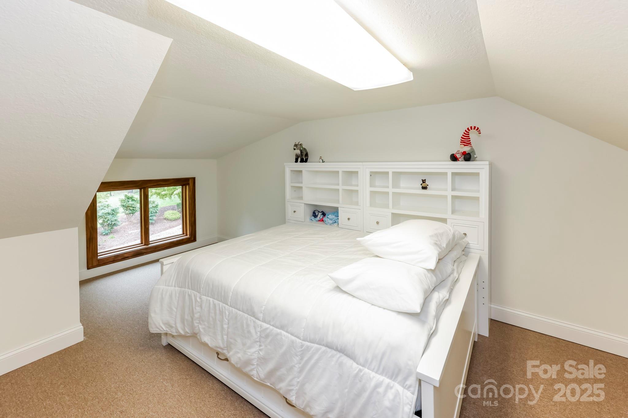 200 Chapel Point Road Lake Lure, NC 28746 - Photo 33 of 48 a bedroom with a bed and a window