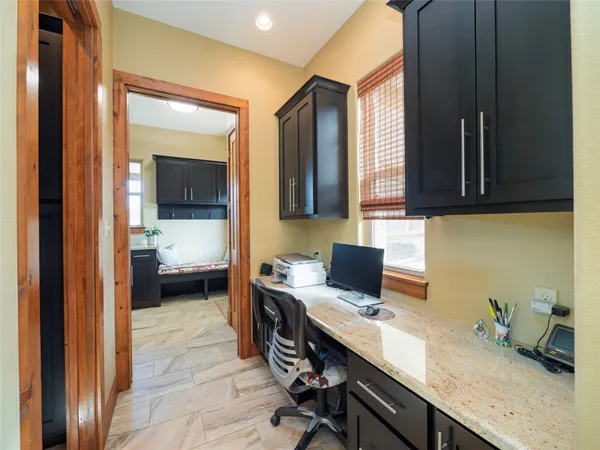a view of a workspace with a window and bathroom