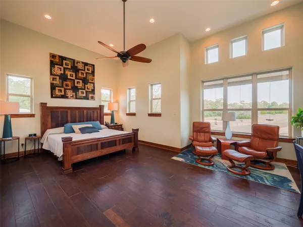a spacious bedroom with a bed and large windows