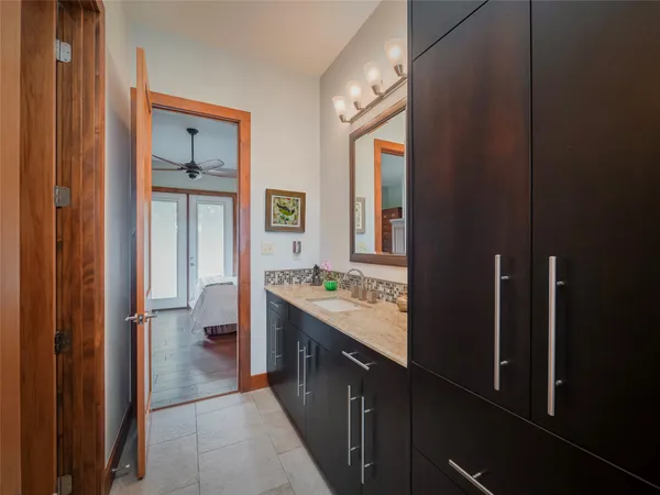a bathroom with a double vanity sink and a mirror