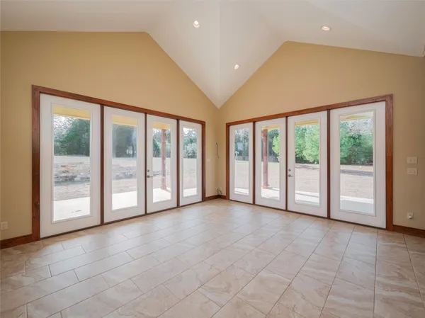 a view of an empty room with glass door