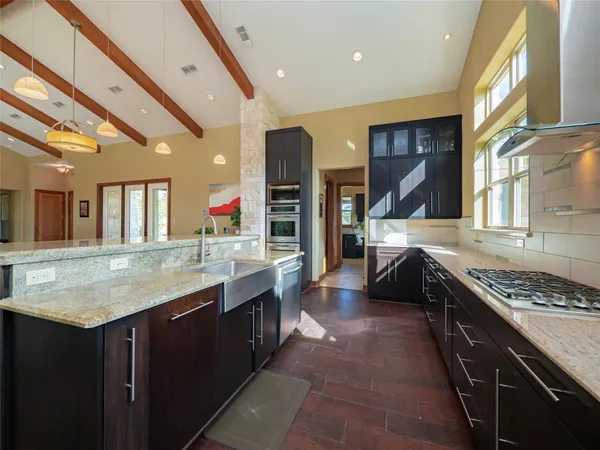 a kitchen with stainless steel appliances granite countertop a sink and stove