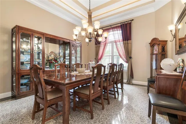 a view of a dining room with furniture and a chandelier