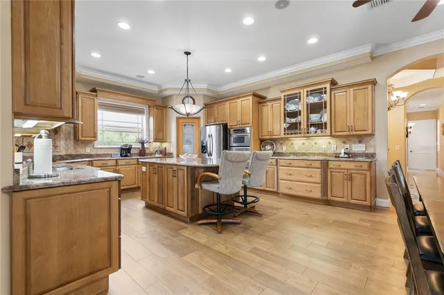 a view of a dining room with furniture and a chandelier