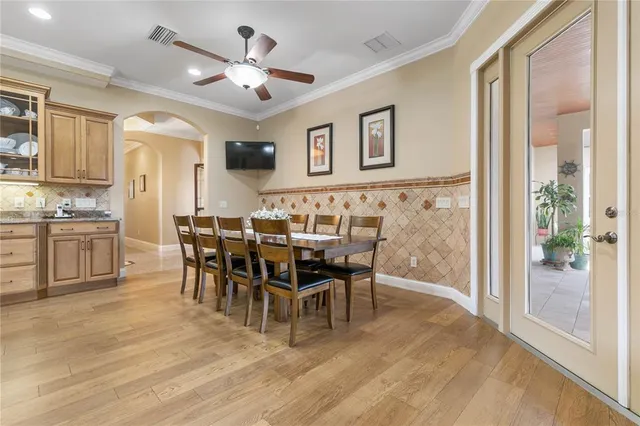 a kitchen with cabinets appliances and a chandelier