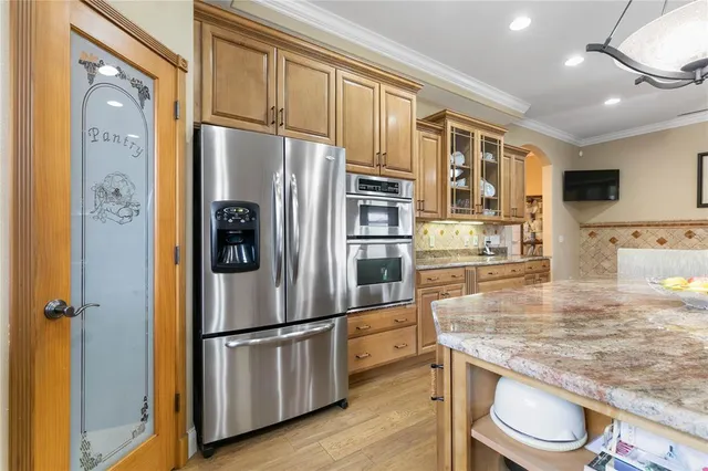 a large kitchen with granite countertop a sink window and cabinets