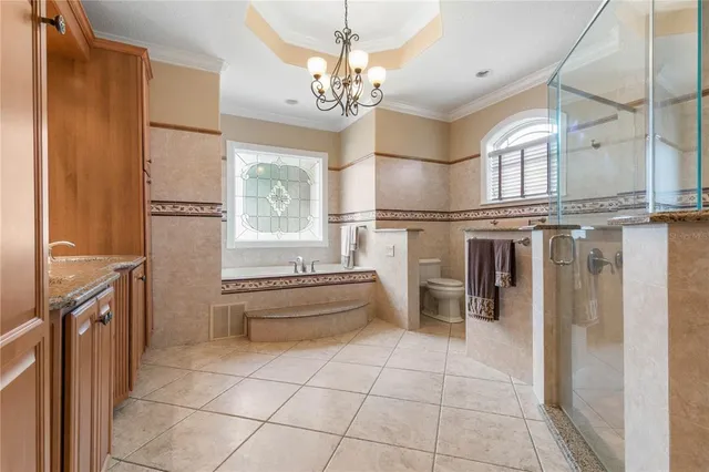 a bedroom with a bed couch and window