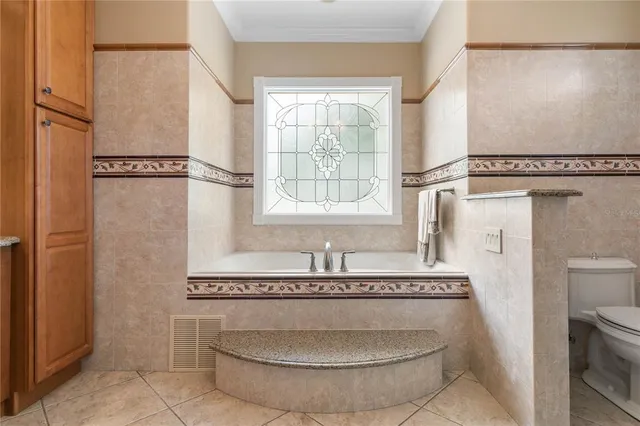 a living room with furniture a window and a flat screen tv