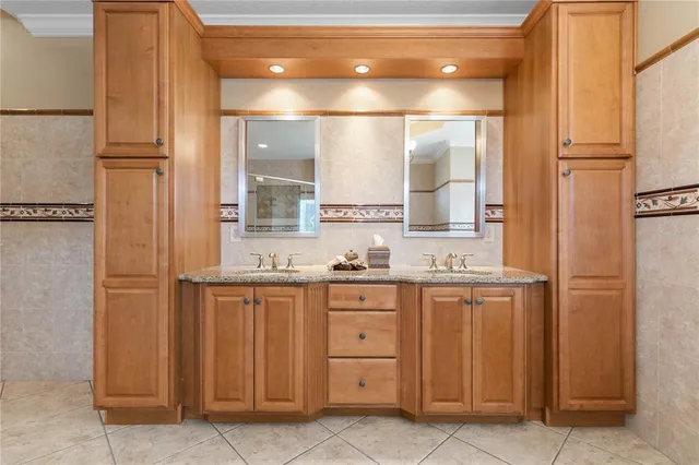 a bathroom with a toilet sink vanity and mirror