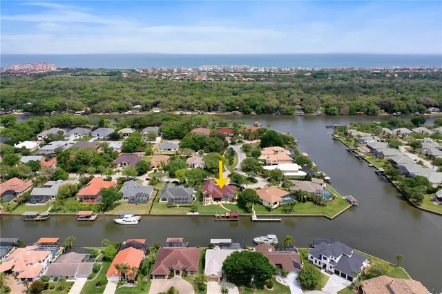 a view of a lake with a table and chairs under an umbrella