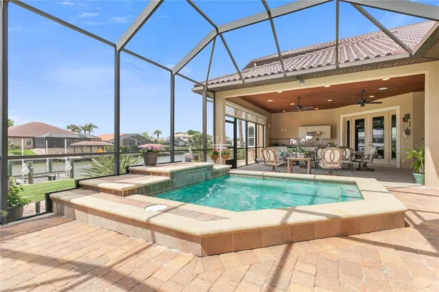 a backyard of a house with yard table and chairs