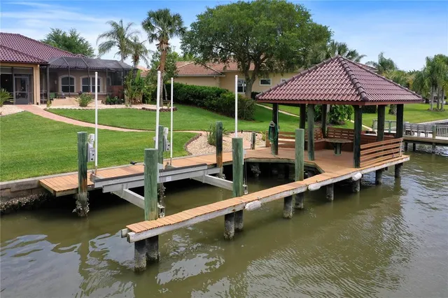 a view of a house with large windows and a small yard