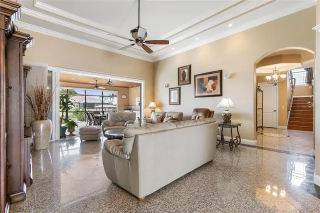 a living room with furniture a flat screen tv and a large window
